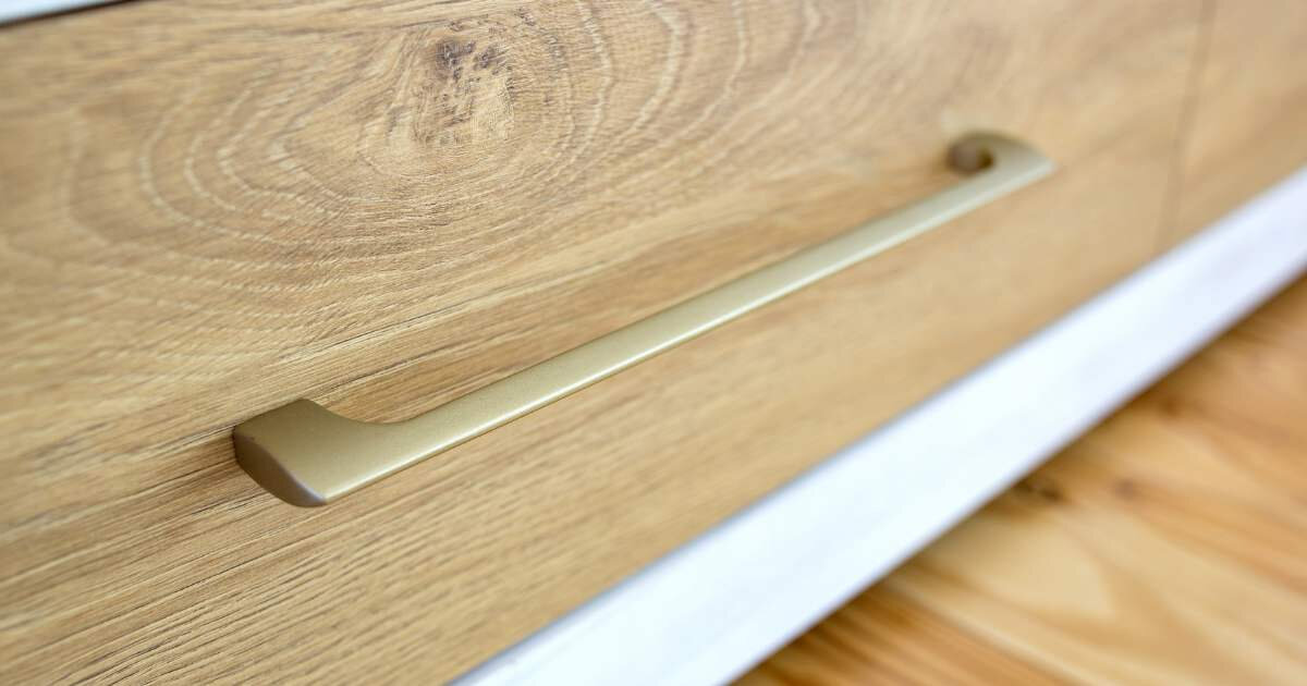 close up view of dresser drawers with light wood stain 